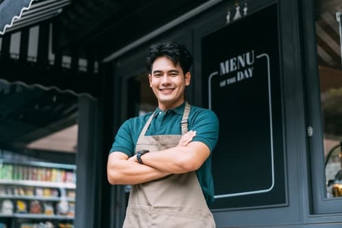 Staff member holding open sign